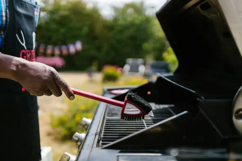 Arion Clean professional cleaner scrubbing a gas grill